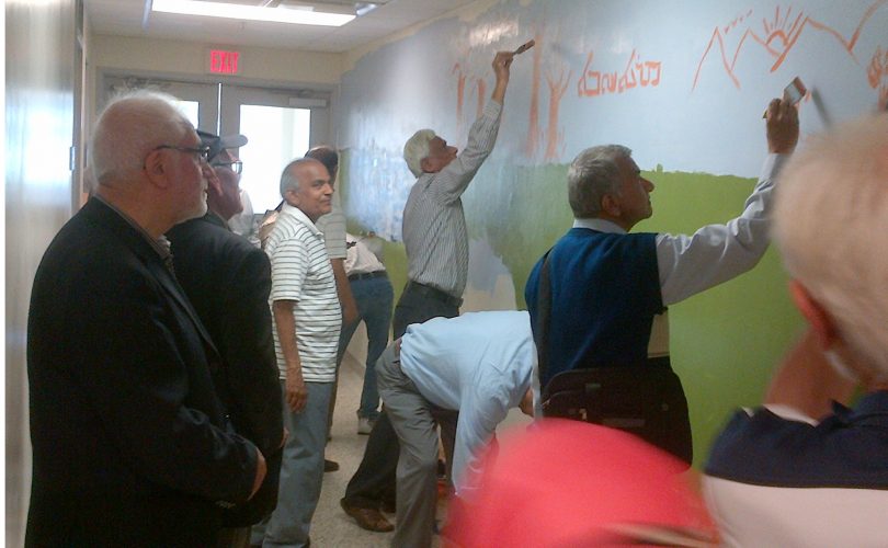 Seniors helping to paint a mural