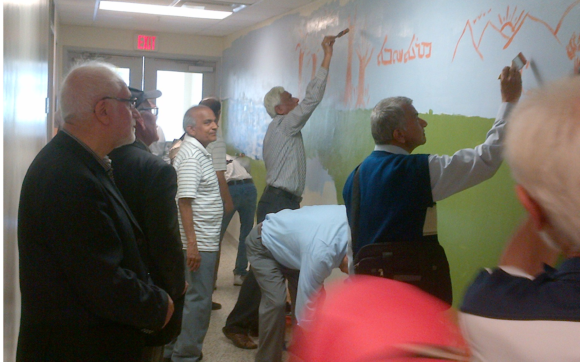 Seniors helping to paint a mural