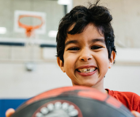 Boy in Rexdale Hub gym with basketball